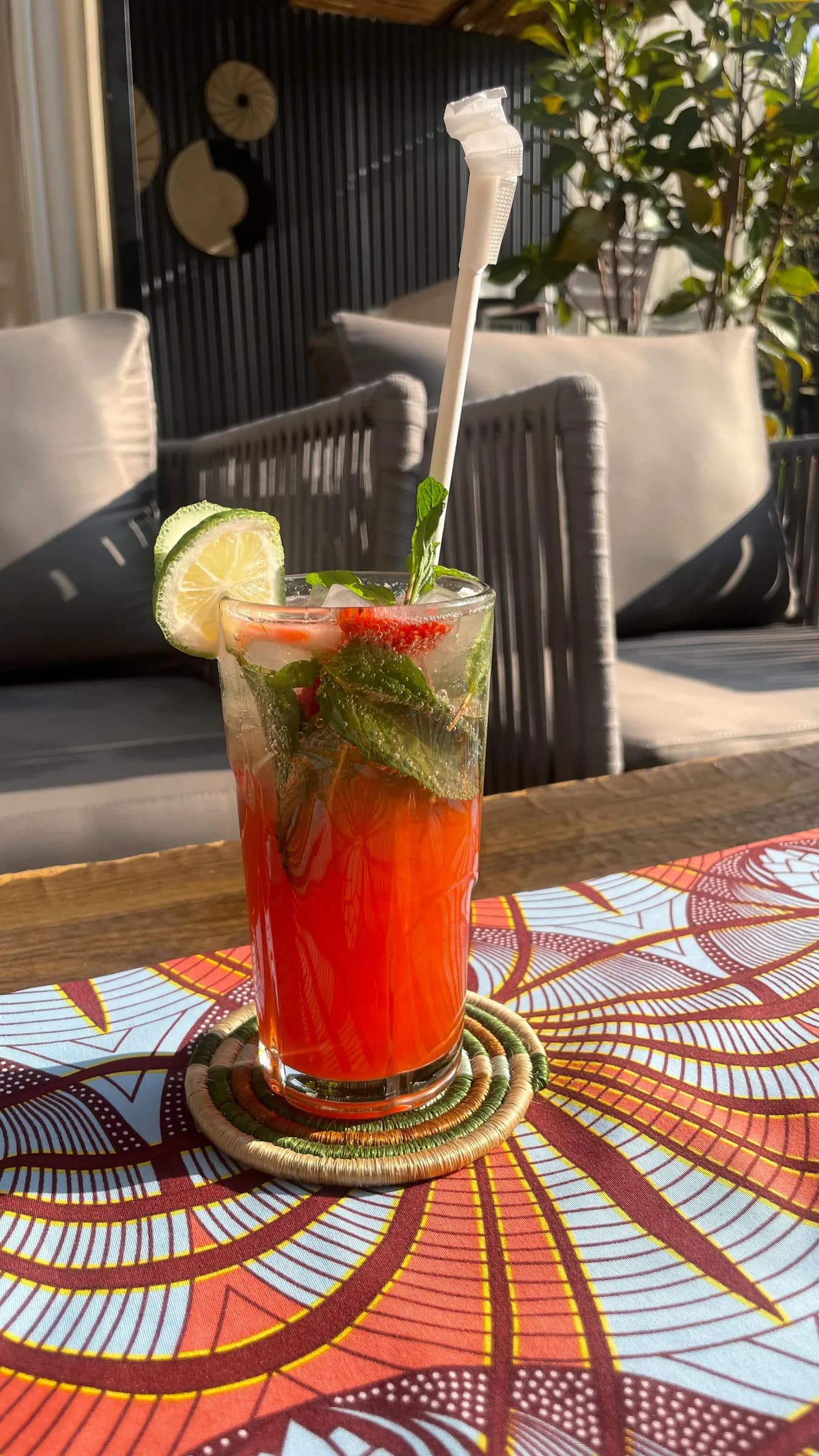 A tall cocktail on a patterned mosaic table at Kalih Villa